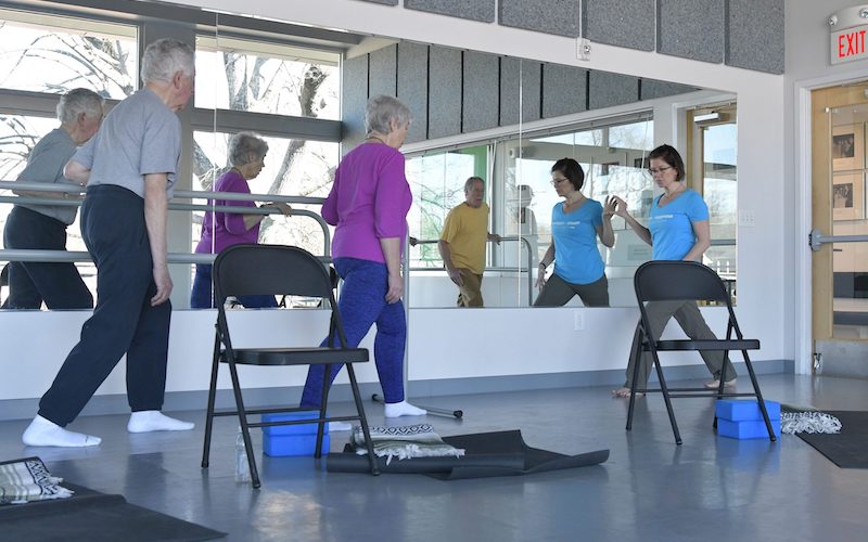 Two PMI students working with an instructor