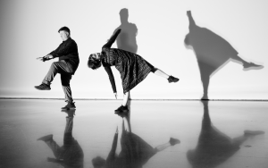 Chris Yon and Taryn Griggs moving in a space with distinct shadows on the wall and floor