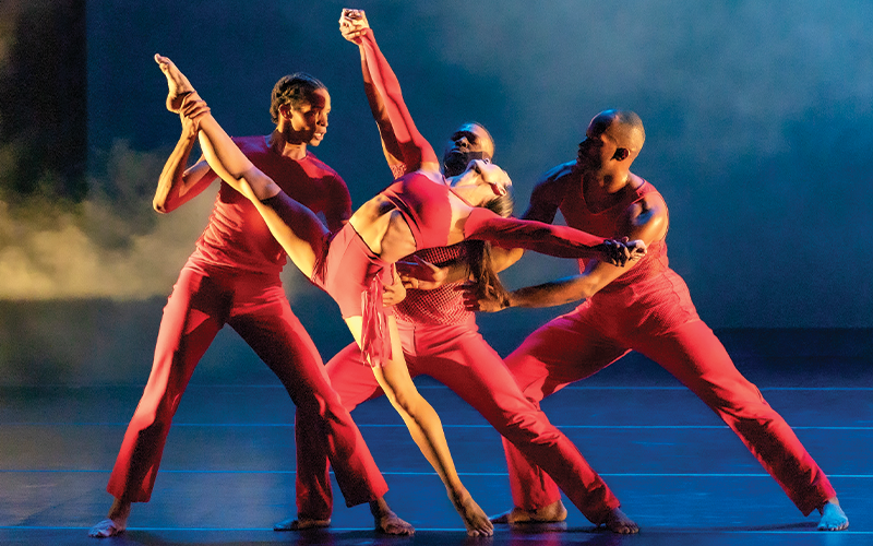 Four Philadanco performers dancing onstage