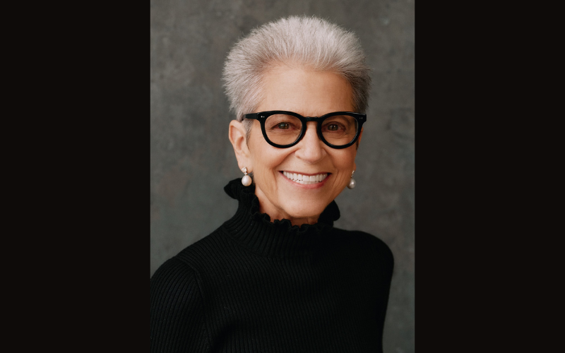7 dancers jumping in a white room.